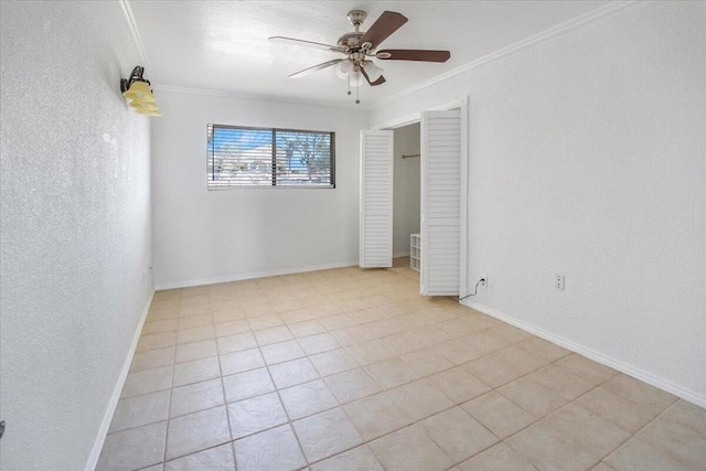 unfurnished room featuring ornamental molding, ceiling fan, and light tile patterned floors