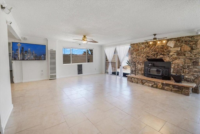 unfurnished living room featuring a textured ceiling, light tile patterned flooring, ceiling fan, and a wood stove