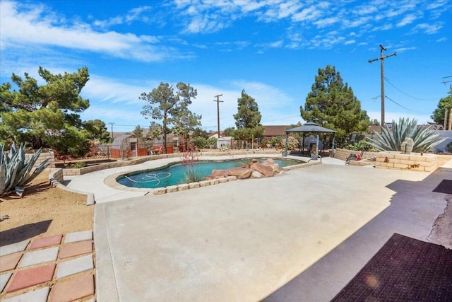 view of swimming pool featuring a gazebo and a patio