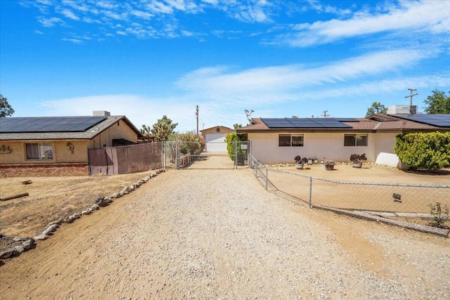 ranch-style house featuring solar panels