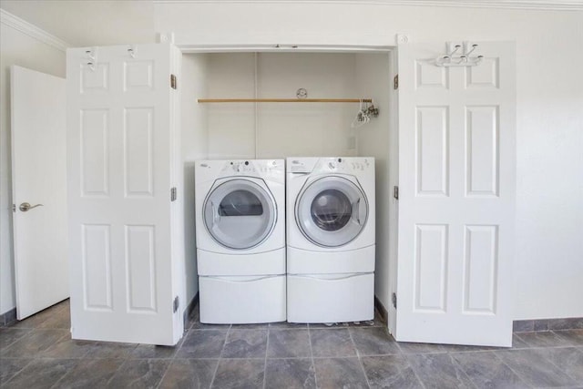 washroom with washer and dryer and crown molding