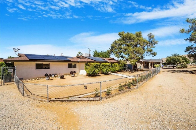 ranch-style home featuring solar panels