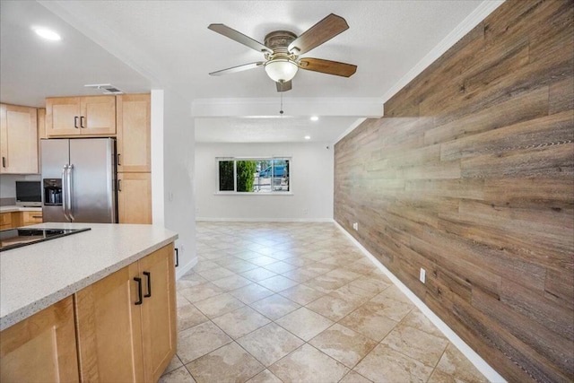 kitchen featuring light tile patterned flooring, ornamental molding, ceiling fan, light brown cabinetry, and stainless steel fridge