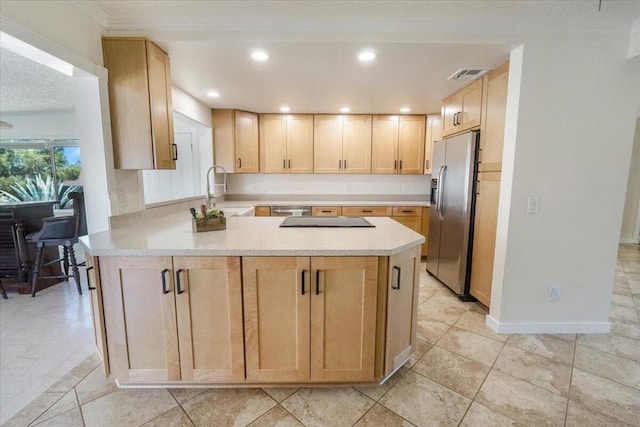 kitchen featuring sink, kitchen peninsula, light brown cabinets, appliances with stainless steel finishes, and crown molding