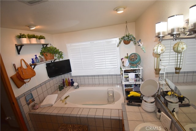 bathroom featuring tiled bath and tile patterned floors