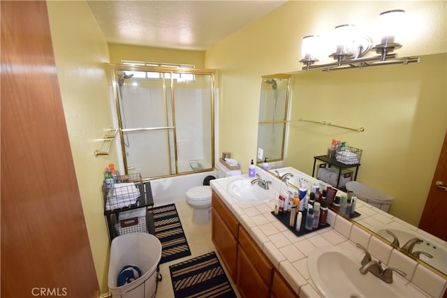 full bathroom featuring enclosed tub / shower combo, a textured ceiling, vanity, and toilet