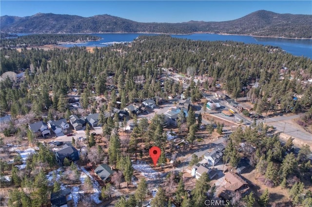 birds eye view of property with a water and mountain view