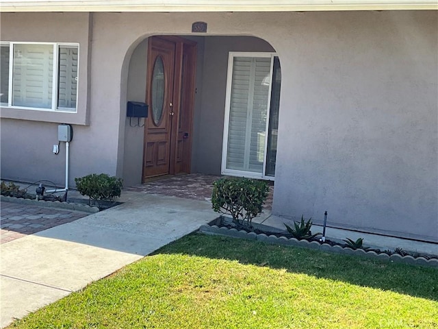 doorway to property featuring a yard