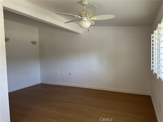 spare room with ceiling fan and dark hardwood / wood-style flooring