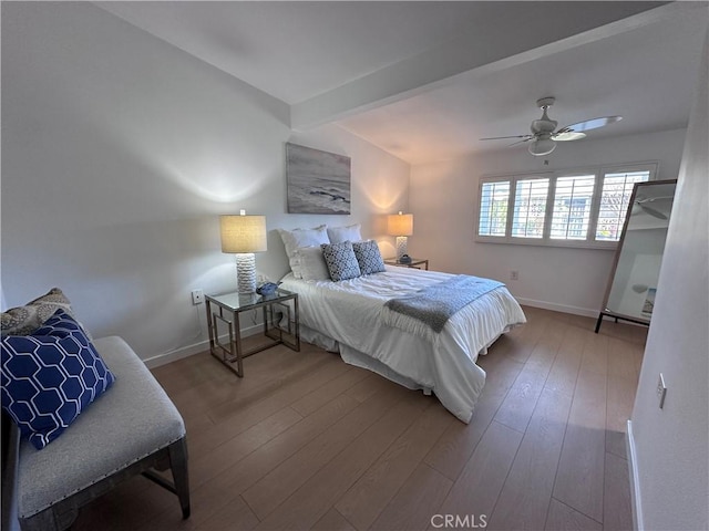 bedroom featuring hardwood / wood-style floors, beamed ceiling, and ceiling fan