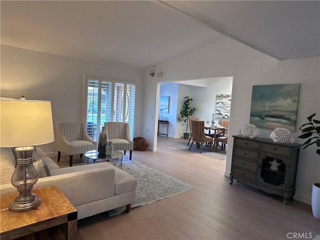 living room with vaulted ceiling and hardwood / wood-style floors