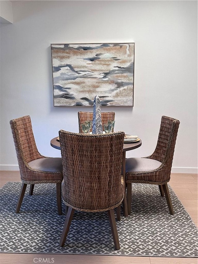 dining area with hardwood / wood-style flooring