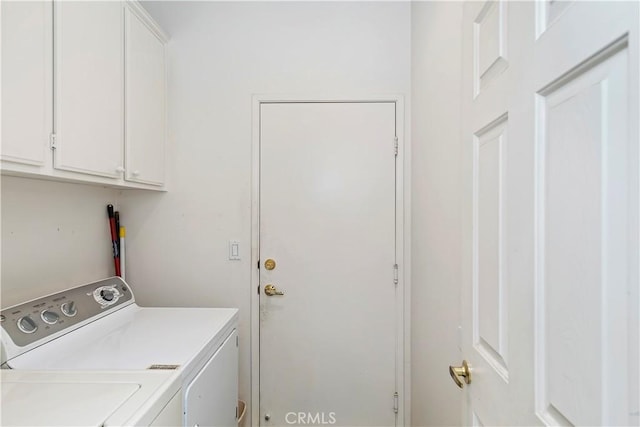 laundry room with cabinets and separate washer and dryer