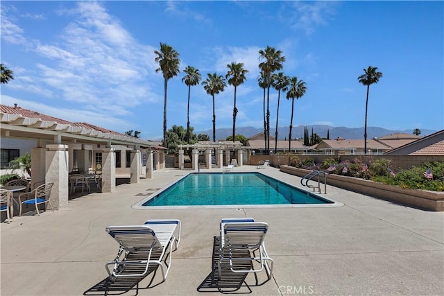 view of swimming pool featuring a mountain view and a patio area