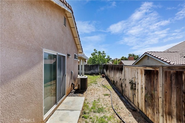 view of side of property featuring central AC