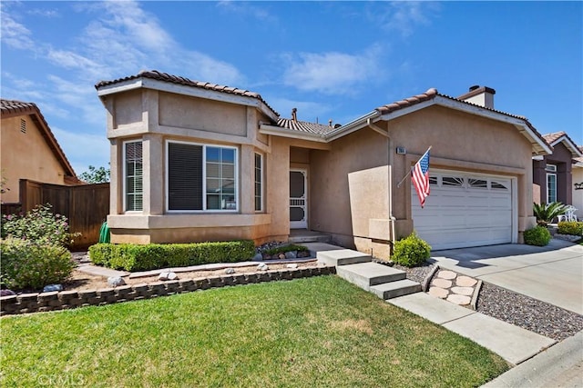 view of front of property with a front yard and a garage