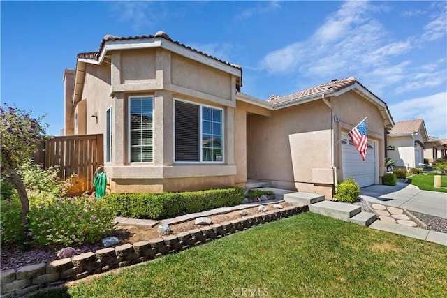 view of front of property featuring a garage and a front lawn