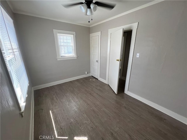 unfurnished bedroom featuring dark wood-type flooring, ceiling fan, and ornamental molding