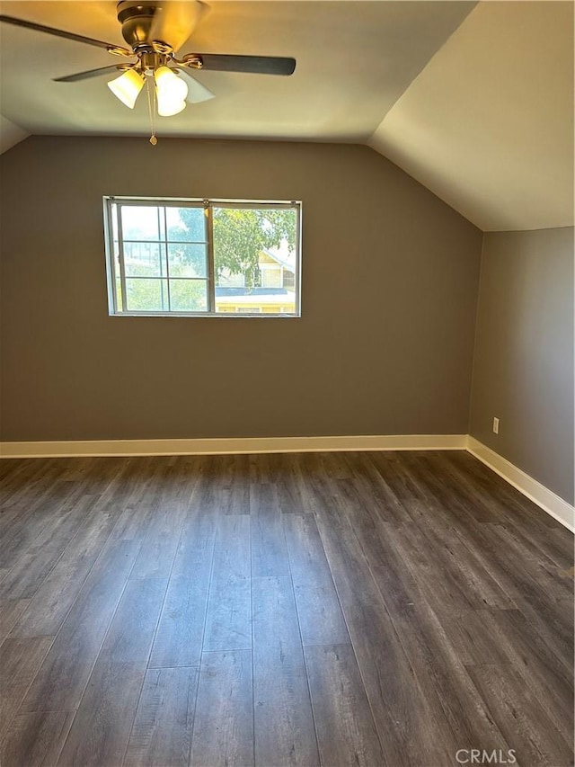 additional living space with vaulted ceiling, ceiling fan, and dark hardwood / wood-style flooring