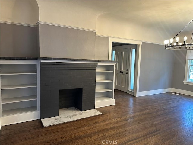 unfurnished living room featuring hardwood / wood-style flooring, a chandelier, and a fireplace