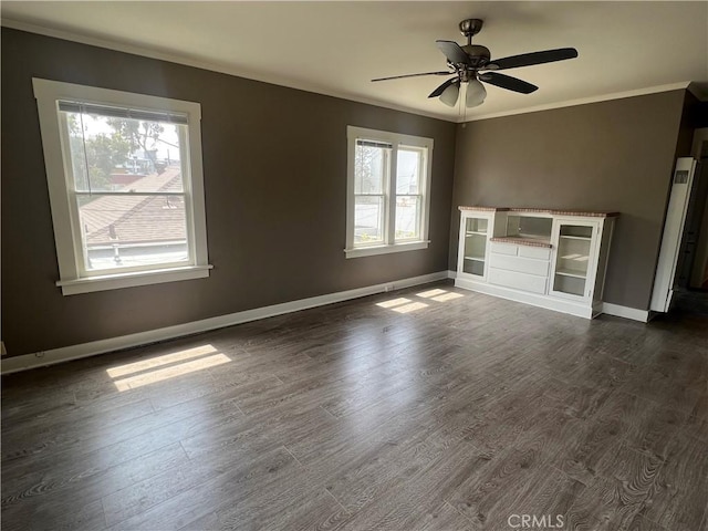 unfurnished living room with dark hardwood / wood-style floors, ceiling fan, and ornamental molding