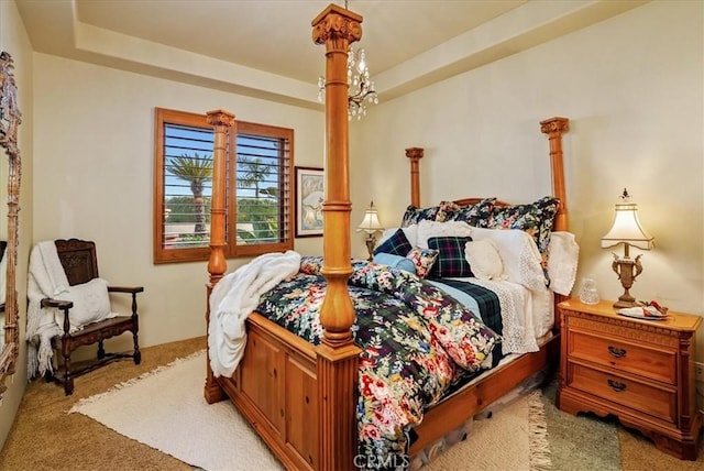 carpeted bedroom with a raised ceiling