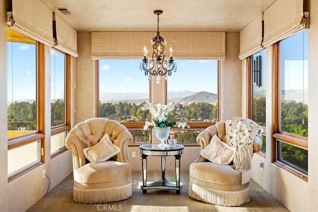 sunroom with a chandelier and a mountain view