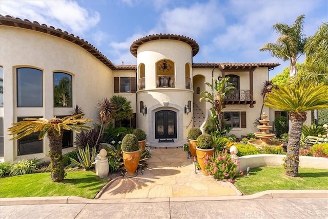 mediterranean / spanish-style house featuring french doors