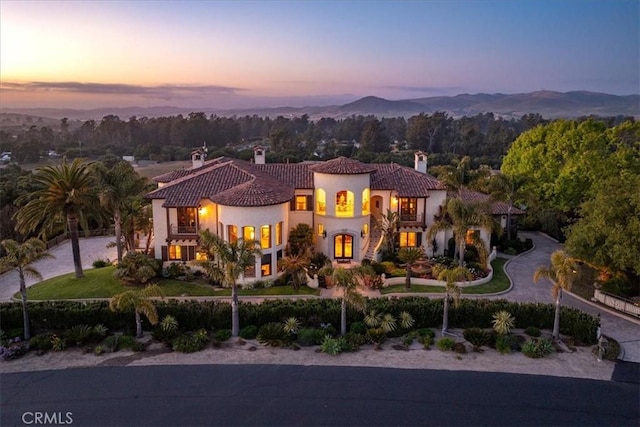 mediterranean / spanish-style house featuring a mountain view and a balcony