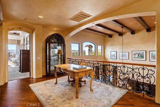 interior space with beam ceiling and dark wood-type flooring