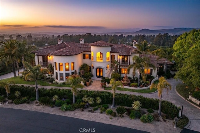 mediterranean / spanish-style house featuring a mountain view and a balcony