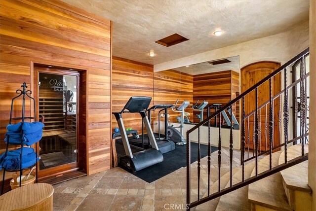 exercise room featuring wooden walls