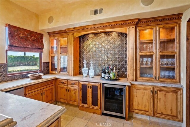 kitchen featuring wine cooler and decorative backsplash