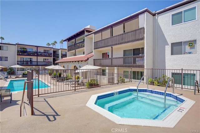 view of pool featuring a community hot tub and a patio