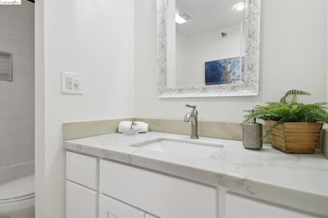 bathroom featuring vanity and toilet