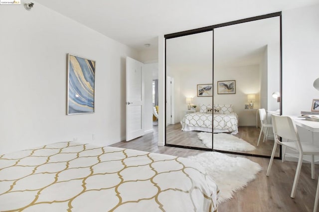 bedroom with hardwood / wood-style flooring and a closet