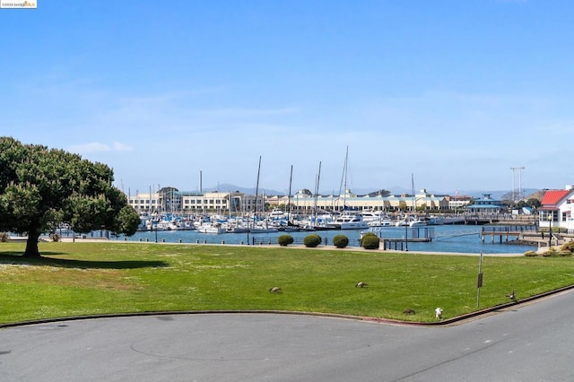 view of community with a lawn and a water view