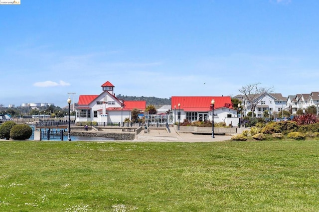 view of play area with a water view and a yard