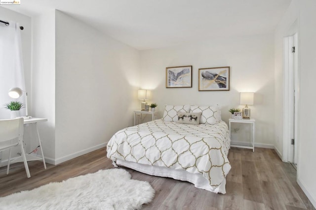 bedroom with hardwood / wood-style flooring