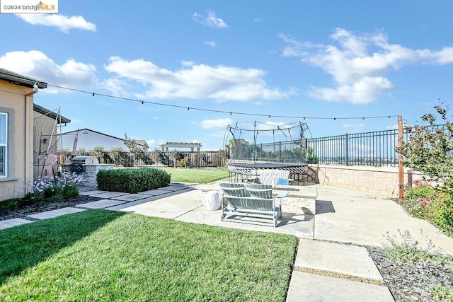 view of yard with a patio area and a trampoline