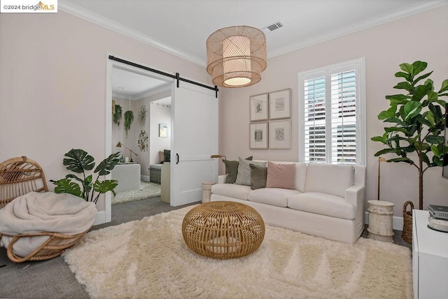 carpeted living room featuring a barn door and ornamental molding