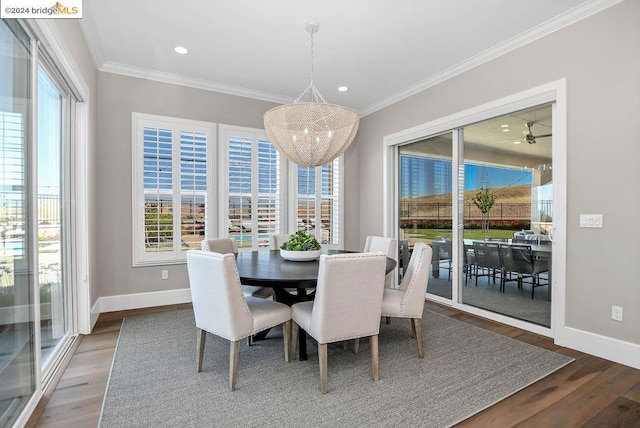 dining area with crown molding, dark hardwood / wood-style flooring, and ceiling fan