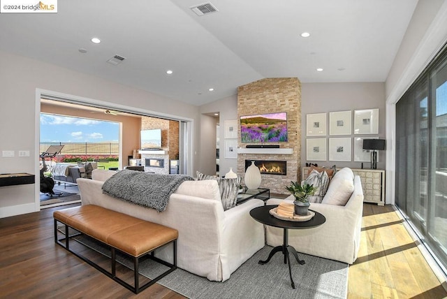 living room featuring a fireplace, hardwood / wood-style flooring, and lofted ceiling