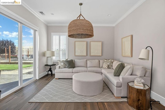 living room with wood-type flooring and ornamental molding