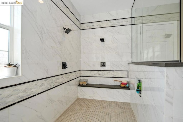 bathroom with a tile shower