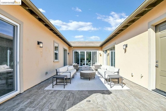 view of patio featuring an outdoor hangout area and a wooden deck