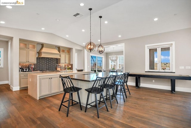 kitchen with premium range hood, dark wood-type flooring, vaulted ceiling, and an inviting chandelier