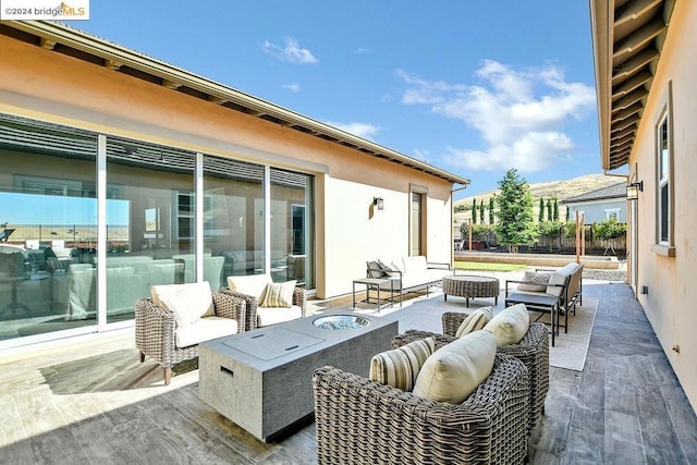 view of patio / terrace with an outdoor living space with a fire pit