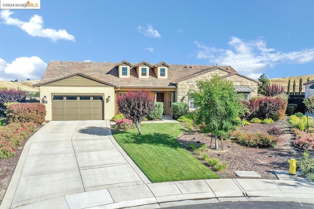 view of front of house with a front yard and a garage