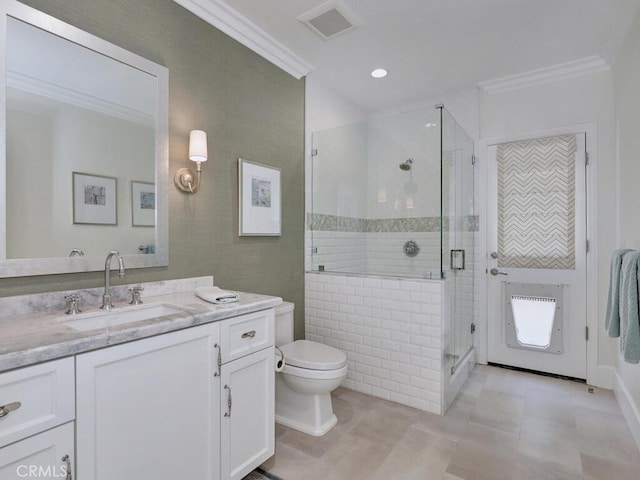 bathroom with tile patterned floors, vanity, toilet, and ornamental molding